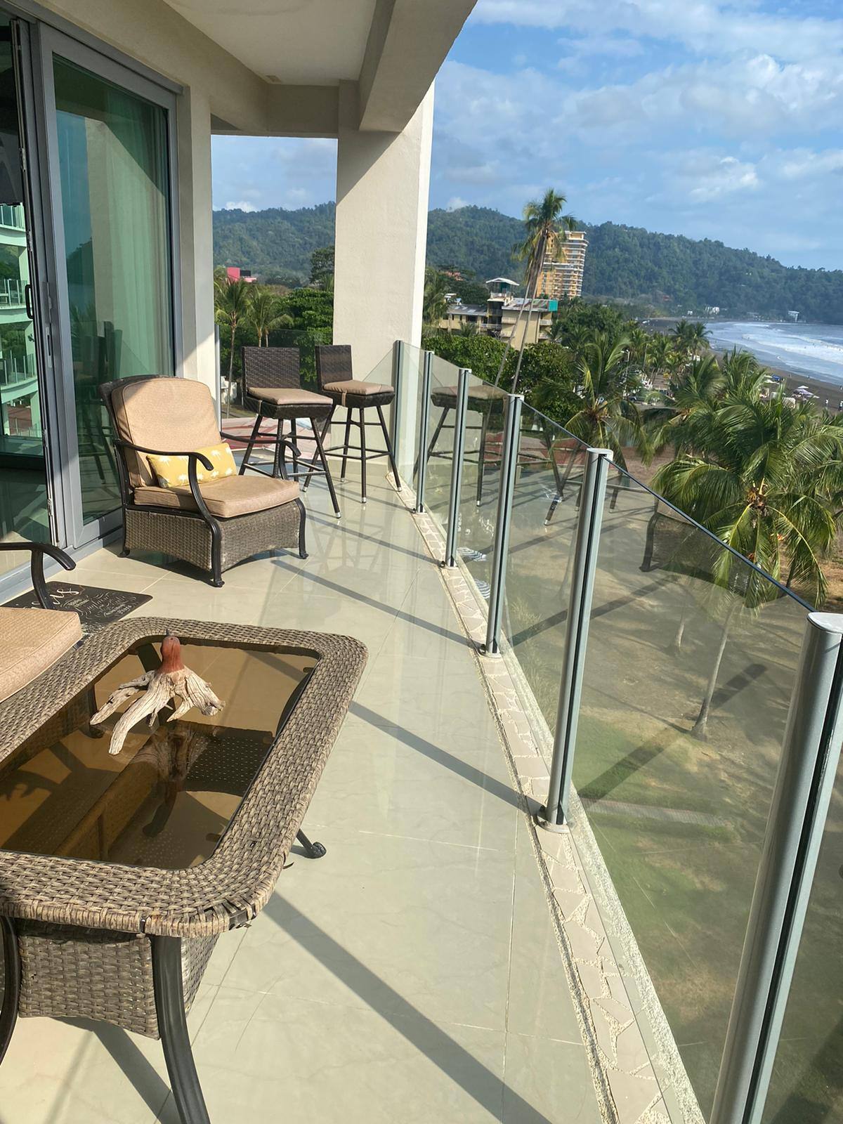 Spacious wraparound balcony with lounge seating and ocean views